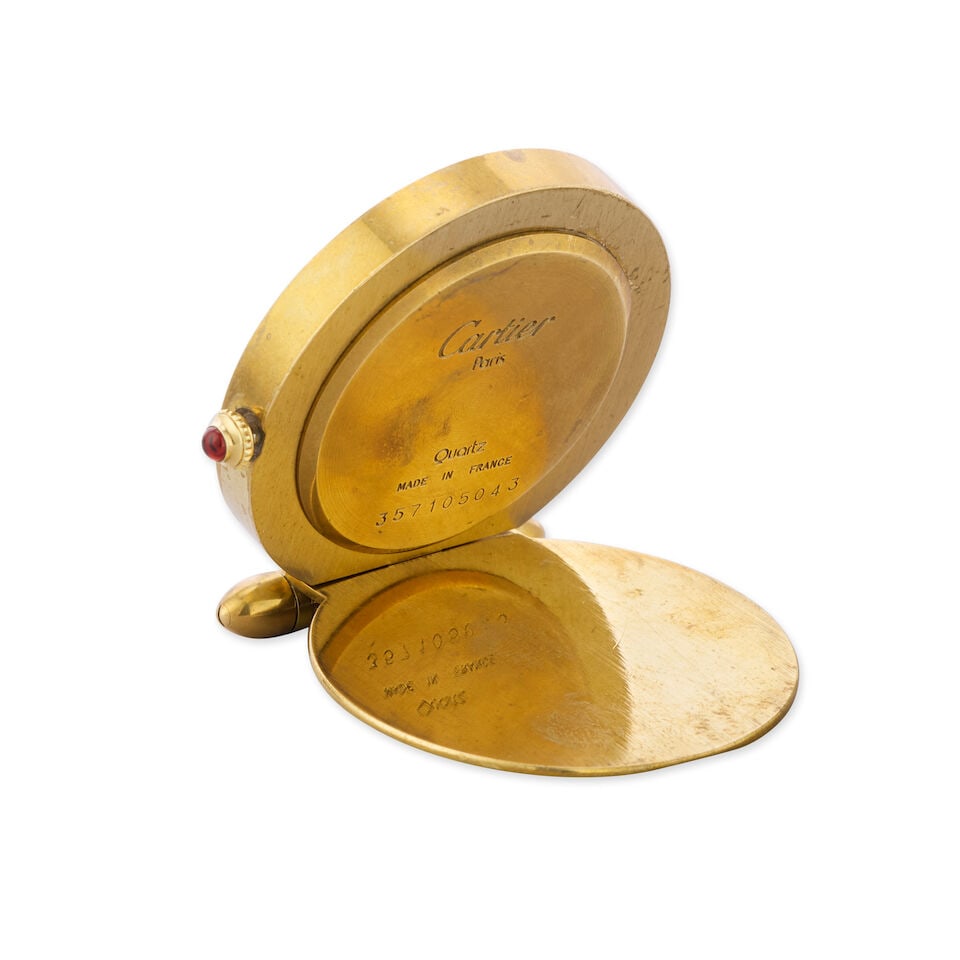 Cartier. A gilt and enamel quartz travel clock with alarm Circa 1980 - 2