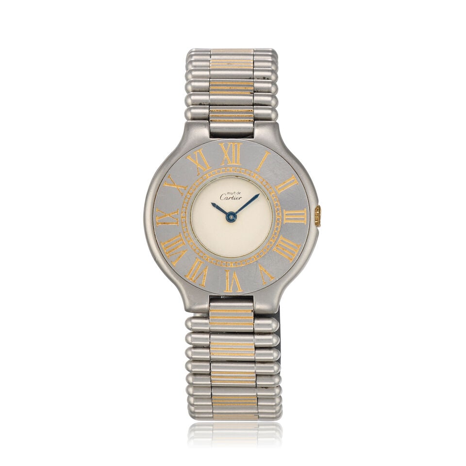 Cartier. A stainless steel and gold quartz bracelet watch Must de Cartier 21 , Circa 1998: Cartier. A stainless steel and gold quartz bracelet watch Model: Must de Cartier 21 Date: Circa 1998 Movement: Jewelled Cal.81 quartz Dial: Cream Case: Brushed and polished round,