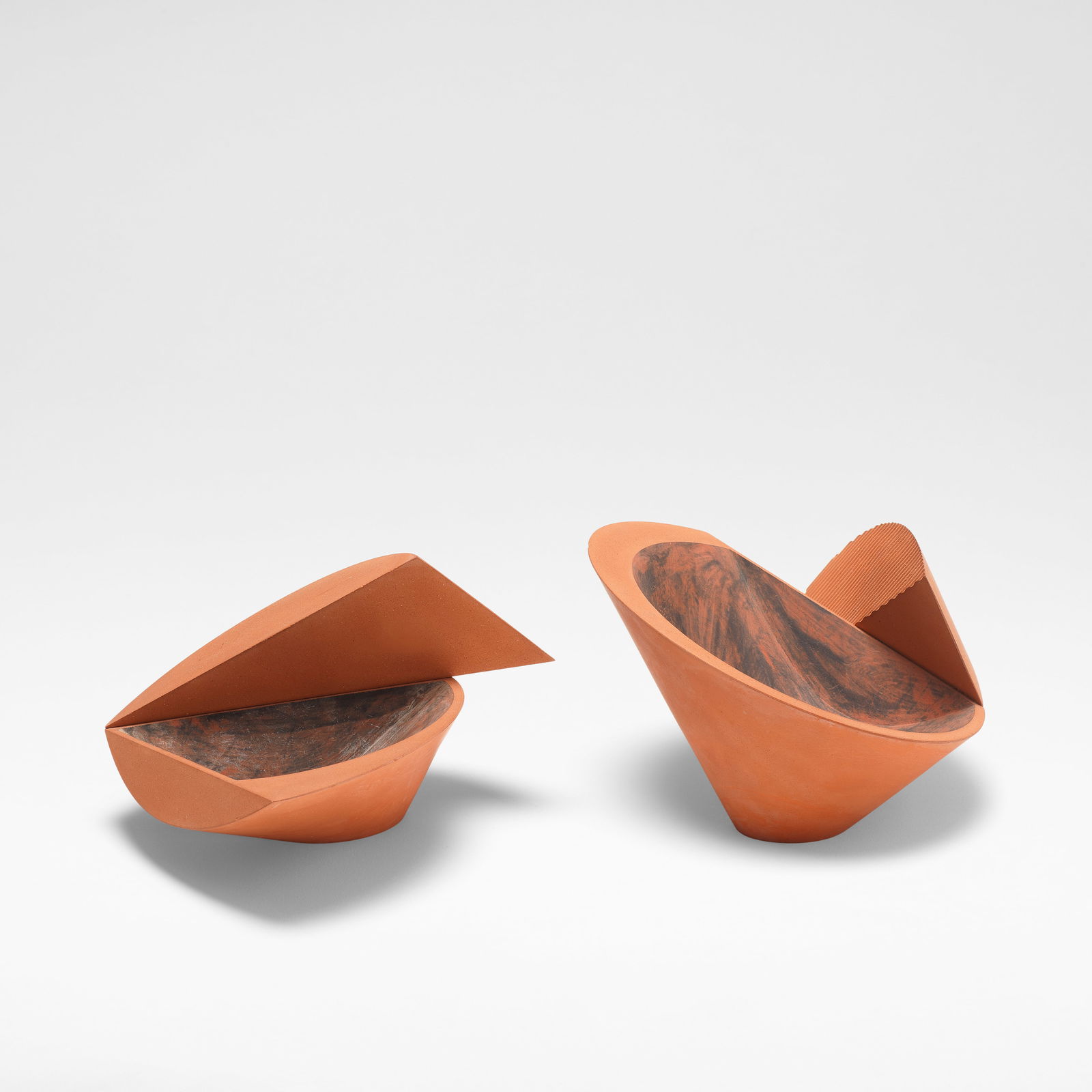 Martin Smith Two small bowls, circa 1985: Martin Smith Two small bowls, circa 1985 Red earthenware, painted black and white underglaze colours to wells, with impressed ribbed texture to edge of smaller bowl. Larger: 9.5 cm high, 16.5 cm wide,