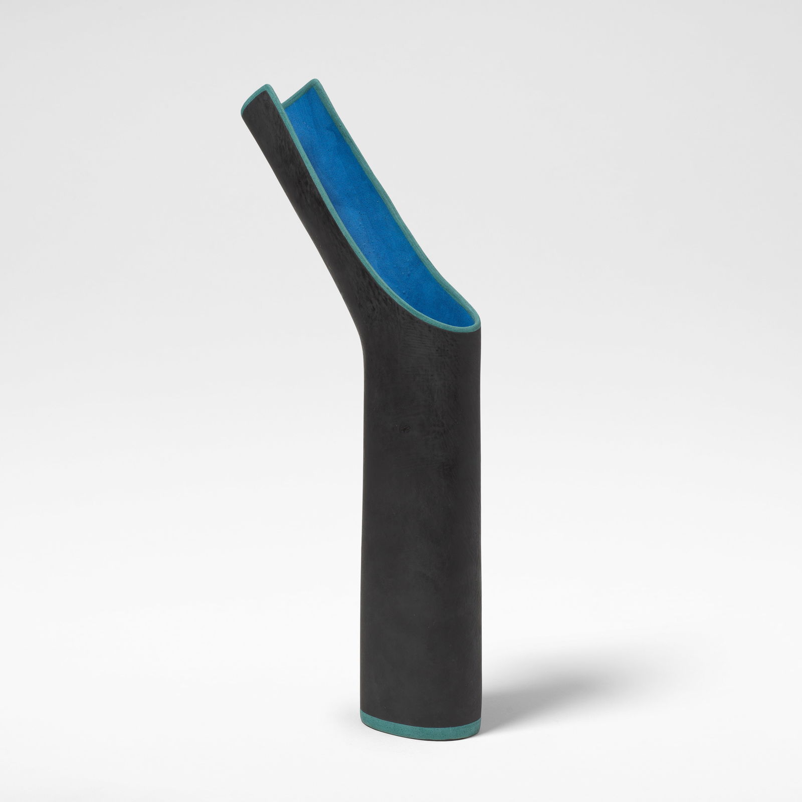 Elizabeth Fritsch Spout pot, circa 1999: Elizabeth Fritsch Spout pot, circa 1999 Hand-built stoneware, the exterior decorated in matte black slip with blue banding, the interior in mottled blue. 39 cm high, 19 cm wide, 4.8 cm wide Footnotes: