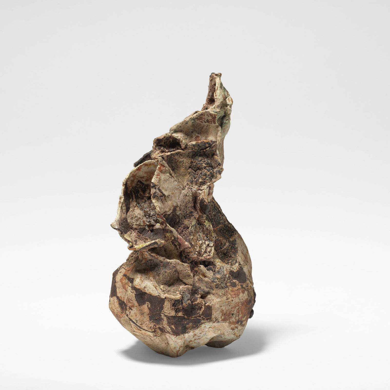 Ewen Henderson Sculptural form, circa 1990: Ewen Henderson Sculptural form, circa 1990 Mixed laminated clays, dry and volcanic glazes in tones of brown, dark brown, cream and blue, over a heavily textured body. 53 cm high, 31 cm wide, 25 cm dee