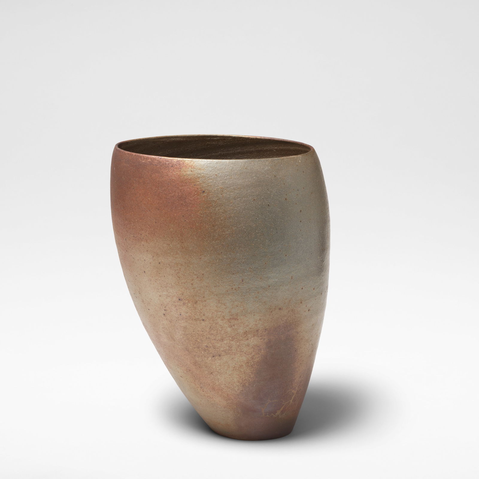 Joanna Constantinidis 'Leaning Pot', circa 1990: Joanna Constantinidis 'Leaning Pot', circa 1990 Stoneware, dry rich brown and lustrous golden bronze surface with iron speckle, the interior with ribbed banding. 31 cm high, 21.5 cm wide, 19.5 cm deep