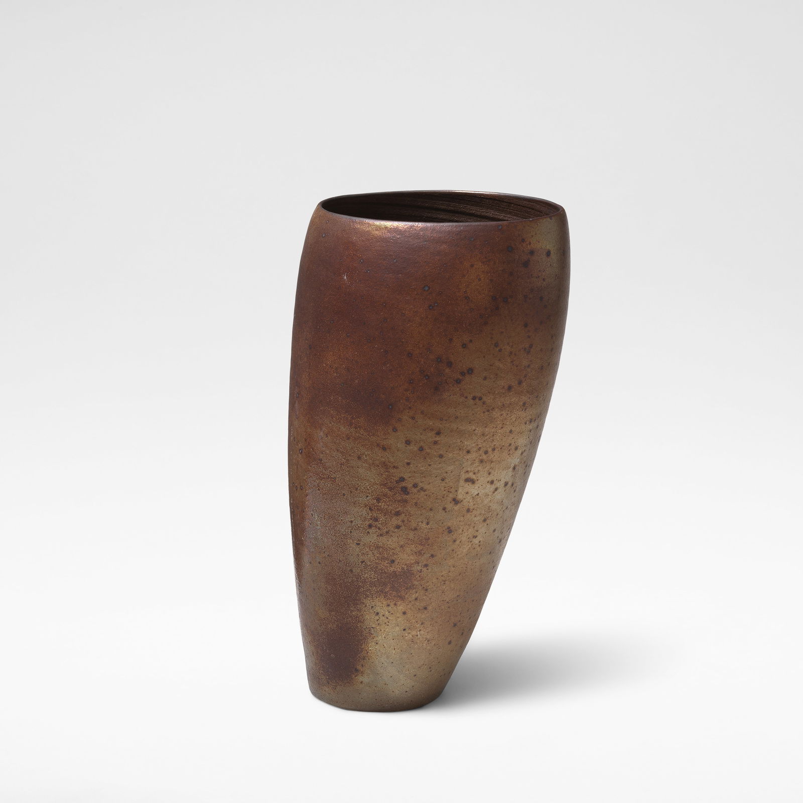 Joanna Constantinidis 'Tall Leaning Pot', circa 1990: Joanna Constantinidis 'Tall Leaning Pot', circa 1990 Stoneware, dry rich brown and lustrous golden bronze surface with iron speckle, the interior with ribbed banding. 42 cm high, 22 cm wide, 19 cm dee