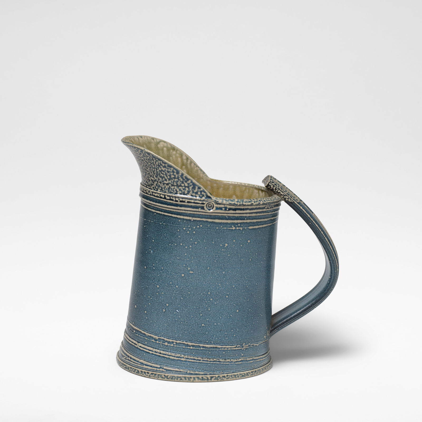 Walter Keeler Large jug: Walter Keeler Large jug Stoneware, pale blue salt glaze with running olive green salt glaze to interior, mounted with a strap handle. 26 cm high, 24.5 cm wide, 14.5 cm deep Impressed twice to the side