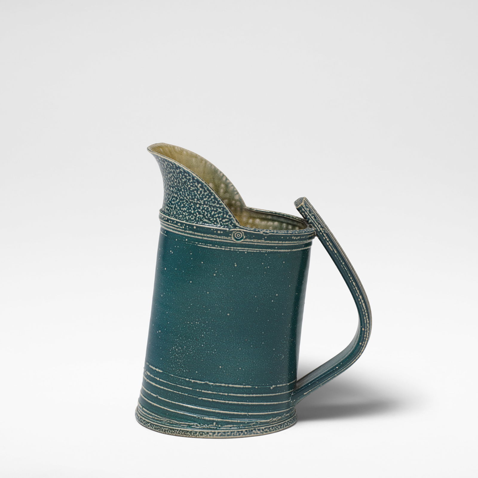 Walter Keeler Large jug: Walter Keeler Large jug Stoneware, deep teal salt glaze with running olive green and brown salt glazes to interior, mounted with a strap handle. 26.5 cm high, 22 cm wide, 13 cm deep Impressed twice to