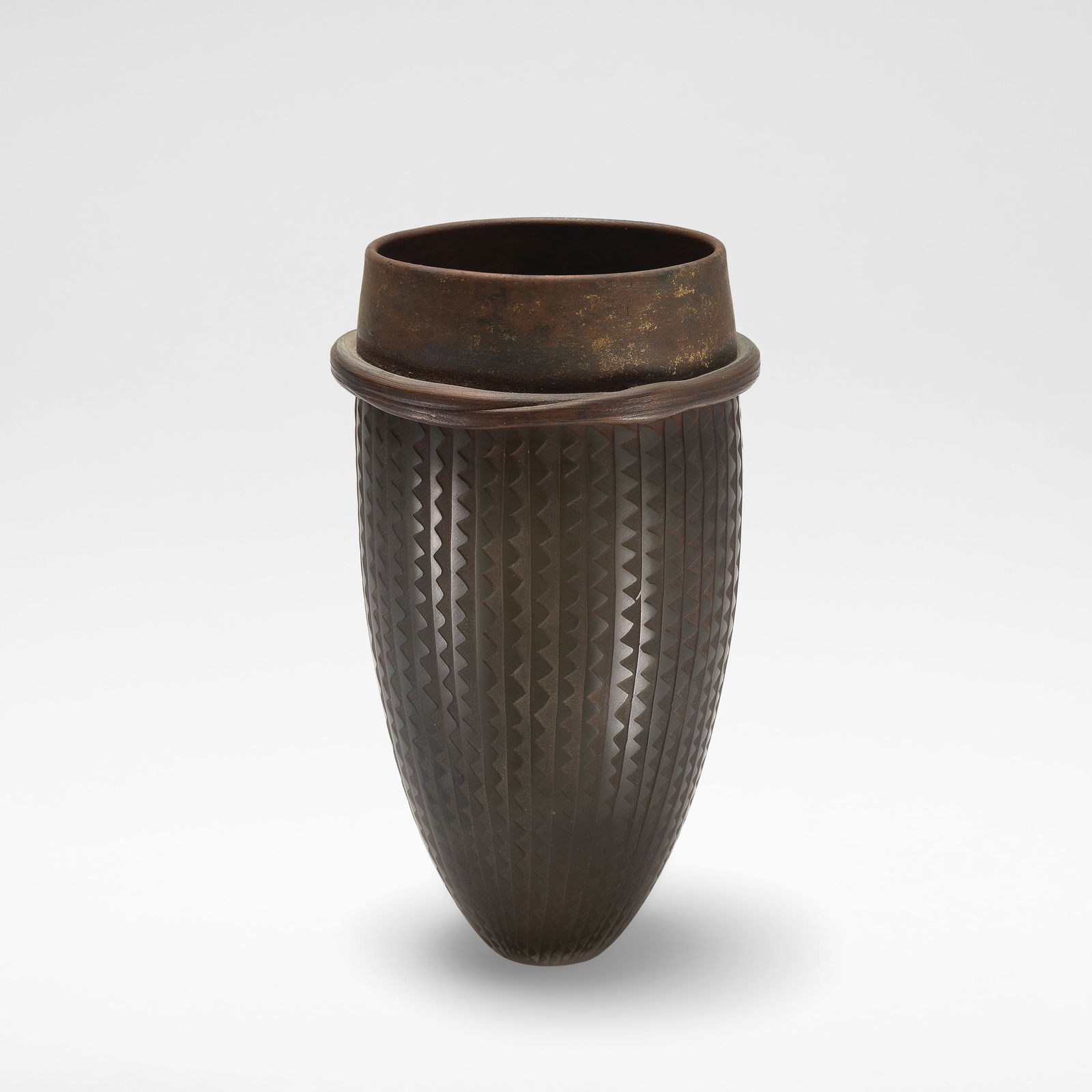 Anna Dickinson Vase, 1989: Anna Dickinson Vase, 1989 Handblown glass blank by Neil Wilkin, of flared form rising to a plain rim with an applied lip, patinated with electroformed copper, the body etched with jagged motifs. 21.5