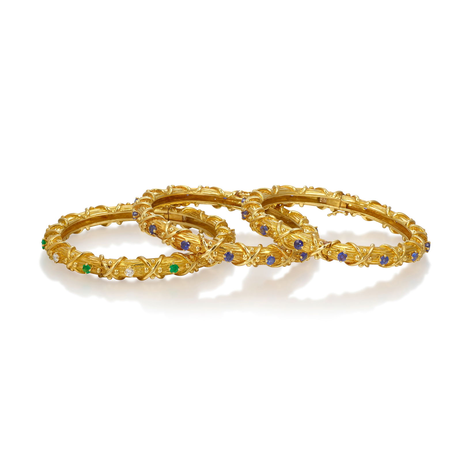 TIFFANY & CO.: A SET OF 18K GOLD, DIAMOND AND GEM-SET BRACELETS, CIRCA 1970 (1 of 1)