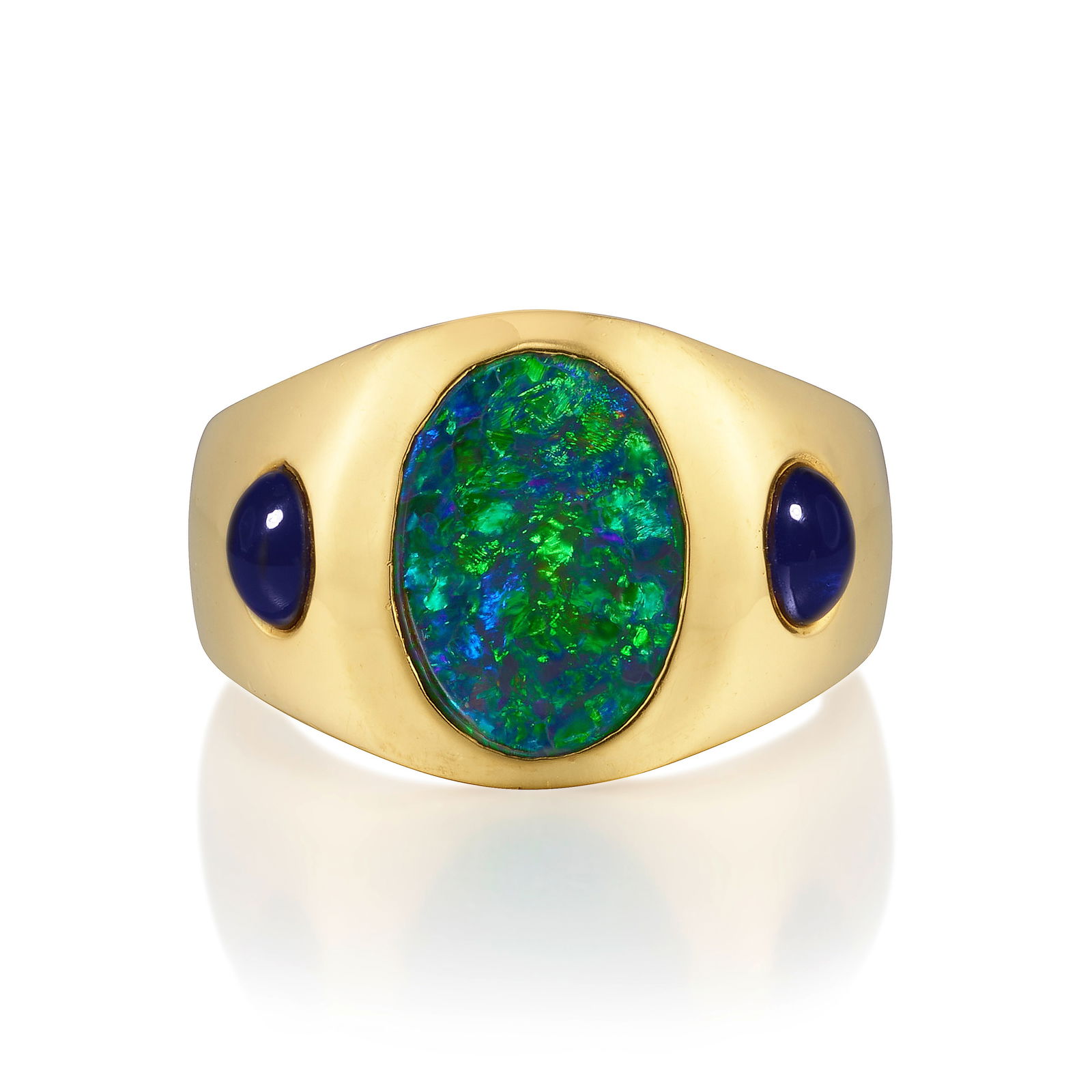 A BLACK OPAL AND SAPPHIRE RING: A BLACK OPAL AND SAPPHIRE RINGCentering an oval-shaped cabochon black opal, flanked by oval-shaped cabochon sapphires; mounted in 22k gold; size 11 1/2Footnotes:Accompanied by GIA Report 1226993352,