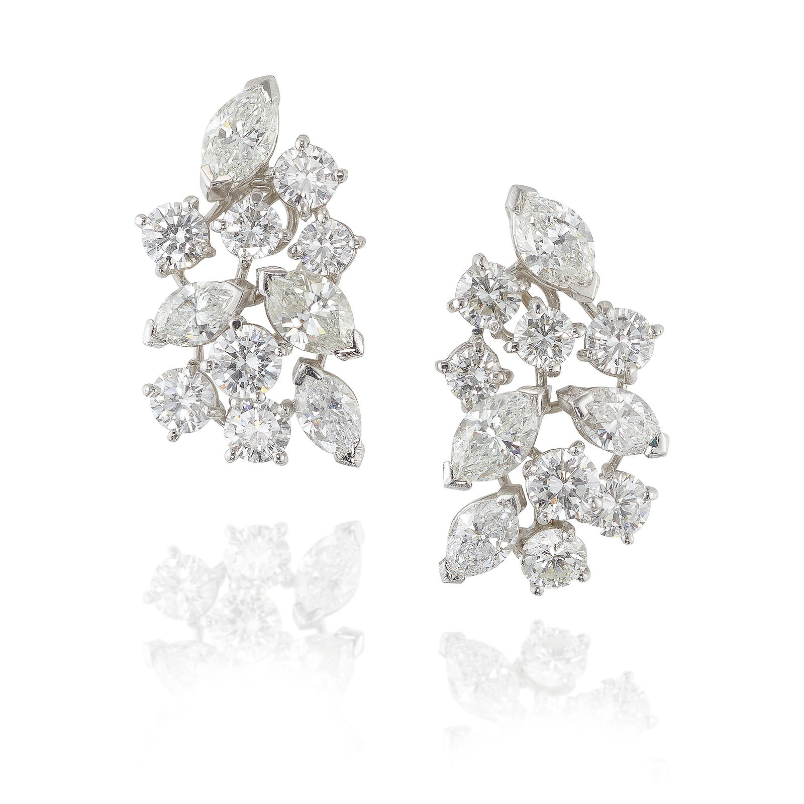 A PAIR OF PLATINUM AND DIAMOND EARCLIPS: A PAIR OF PLATINUM AND DIAMOND EARCLIPSEach designed as clustered pear-shaped and round brilliant-cut diamonds; estimated total weight 5.30 carats; length 15/16 in.Footnotes:OVERALL CONDITION: Metal