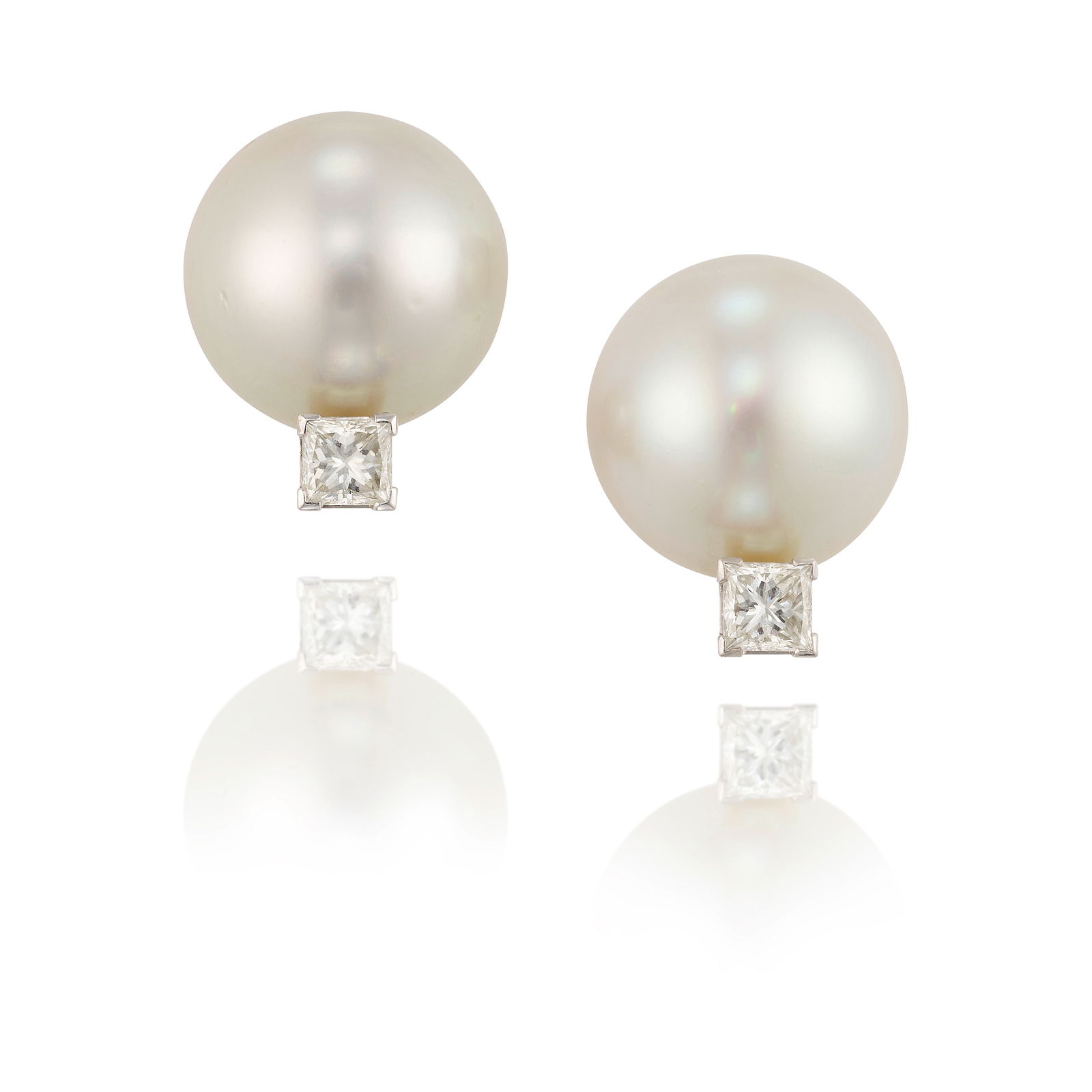 A PAIR OF CULTURED PEARL AND DIAMOND EARRINGS: A PAIR OF CULTURED PEARL AND DIAMOND EARRINGSCentering button cultured pearls, accented by square, mixed-cut diamonds; estimated total diamond carat weight 1.00 carat; mounted in 18k white gold;