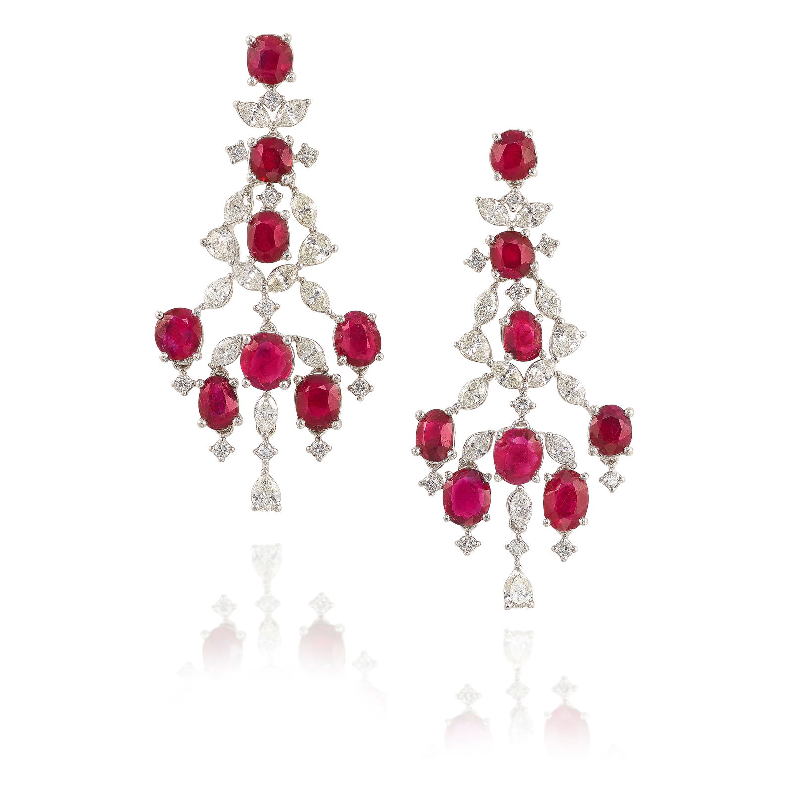 A PAIR OF RUBY AND DIAMOND EARRINGS: A PAIR OF RUBY AND DIAMOND EARRINGS Comprising oval and cushion-shaped rubies, accented with round brilliant-cut, marquise and pear-shaped diamonds; total ruby weight 6.85 carats; estimated total diam