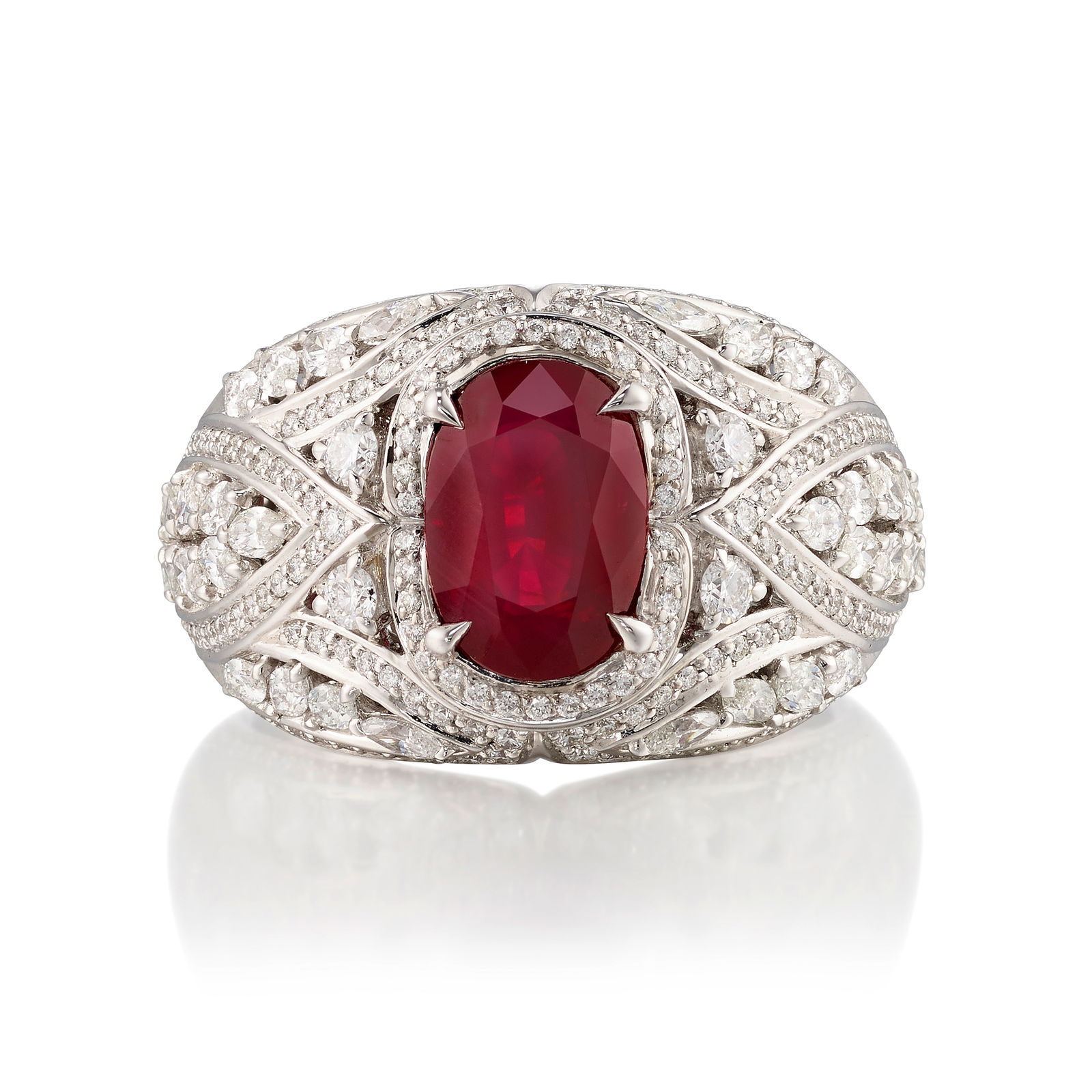 KAT FLORENCE: AN 18K WHITE GOLD, RUBY AND DIAMOND RING: KAT FLORENCE: AN 18K WHITE GOLD, RUBY AND DIAMOND RINGCentering an oval-shaped ruby, in an openwork mounting accented with marquise-shaped and round brilliant-cut diamonds; with maker's mark; with