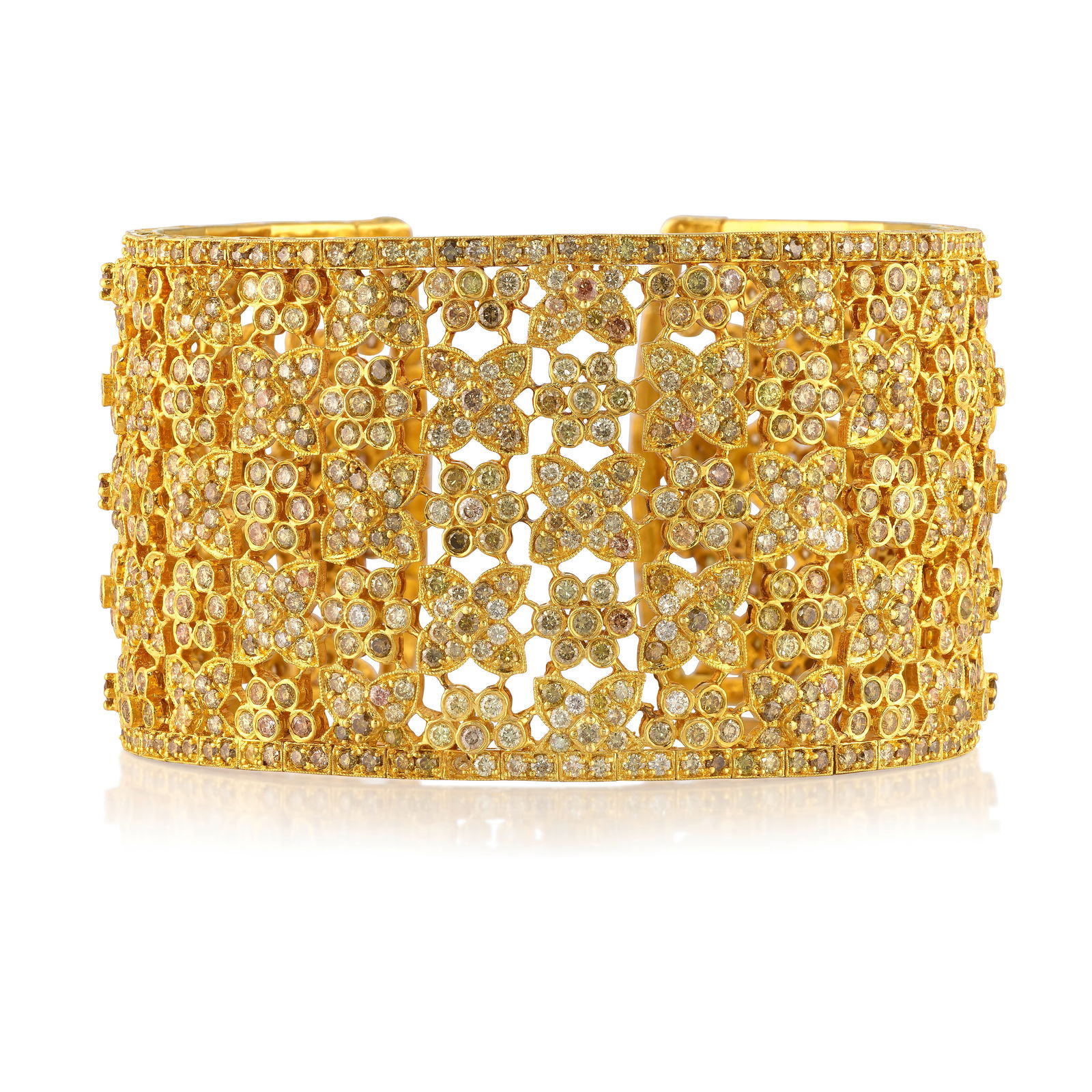 AN 18K GOLD, DIAMOND AND COLORED DIAMOND BRACELET: AN 18K GOLD, DIAMOND AND COLORED DIAMOND BRACELET A flexible cuff, set across with round brilliant-cut diamonds of pink, orange, yellow, brown and green hues; estimated total diamond weight 25.25 car