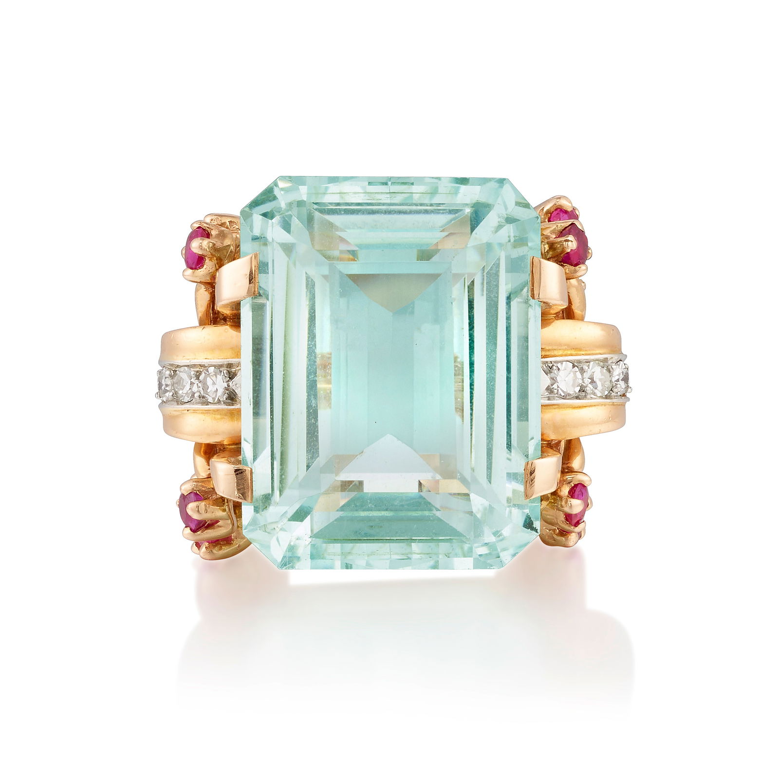AN AQUAMARINE, DIAMOND AND RUBY RING, CIRCA 1945: AN AQUAMARINE, DIAMOND AND RUBY RING, CIRCA 1945 Centering an emerald-cut aquamarine, flanked by sprays of round rubies and rows of single-cut diamonds; estimated aquamarine weight 30.60 carats; mount