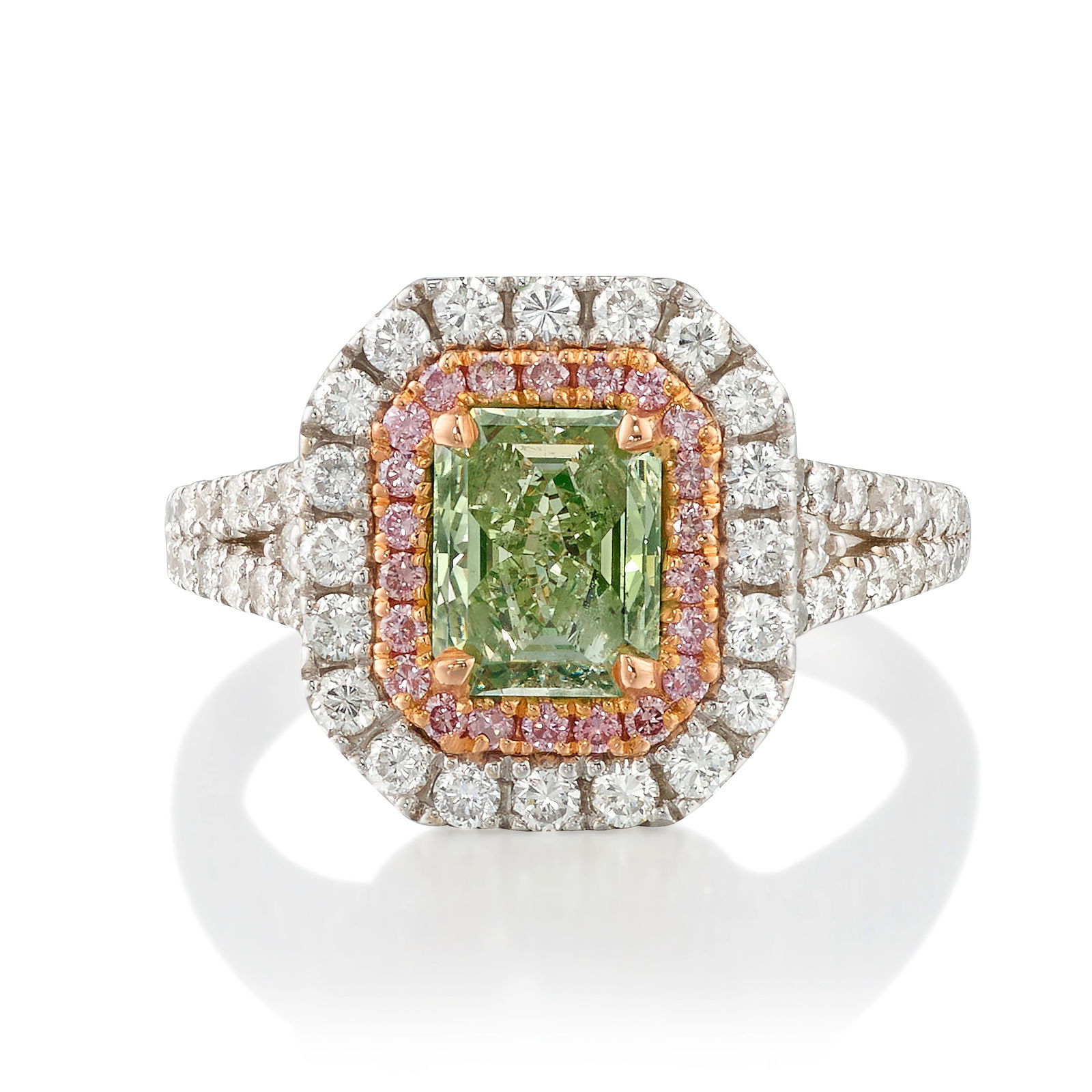 A FANCY LIGHT YELLOW-GREEN DIAMOND AND DIAMOND RING: A FANCY LIGHT YELLOW-GREEN DIAMOND AND DIAMOND RINGCentering a cut-cornered, rectangular mixed-cut diamond weighing 1.20 carats, in a surround of round brilliant-cut diamonds of pink hue, further