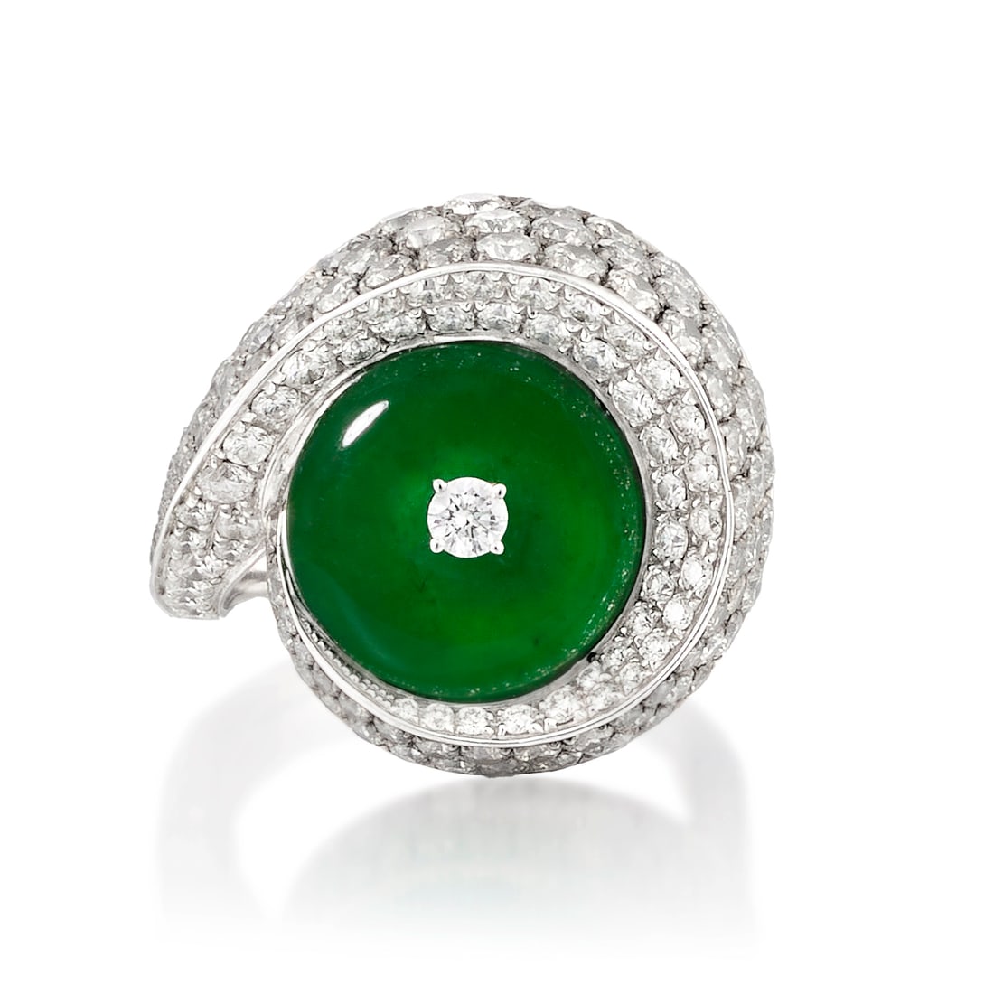 AN 18K WHITE GOLD, JADE AND DIAMOND RING: AN 18K WHITE GOLD, JADE AND DIAMOND RING Centering a jade hololith, in a swirl of pavé-set, round brilliant-cut diamonds; estimated total diamond weight 3.55 carats; size 6 Footnotes: Accompanied