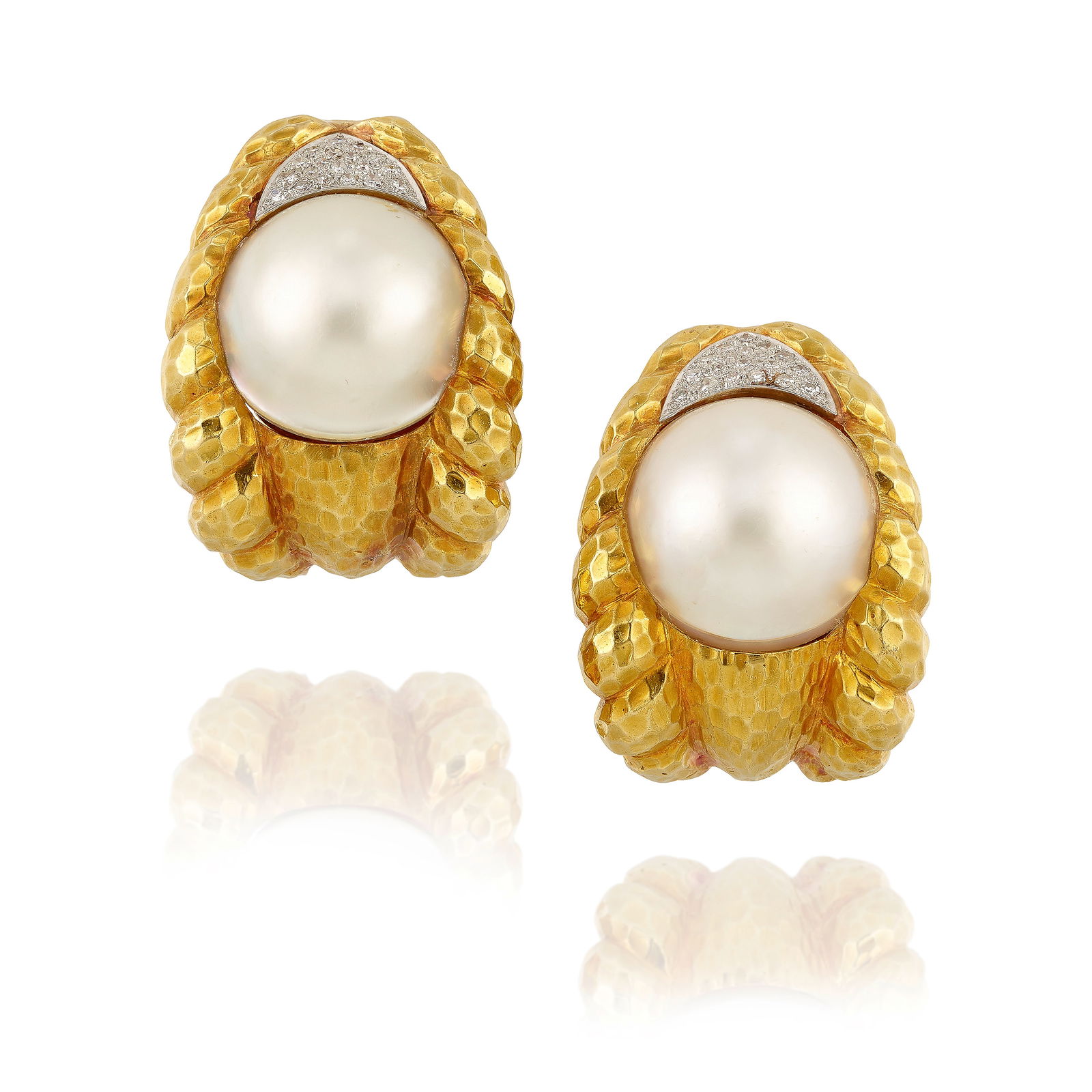 DAVID WEBB: A PAIR OF 18K GOLD, PLATINUM, CULTURED PEARL DOUBLET AND DIAMOND EARCLIPS: DAVID WEBB: A PAIR OF 18K GOLD, PLATINUM, CULTURED PEARL DOUBLET AND DIAMOND EARCLIPSOf hammered gold, each centering a cultured Mabé pearl and mother-of-pearl doublet, accented by