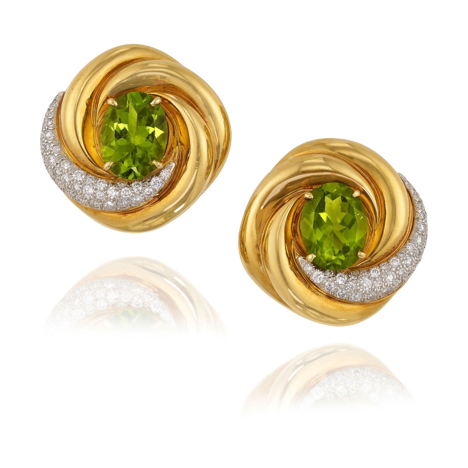ANDREW CLUNN: A PAIR OF 18K GOLD, PLATINUM, PERIDOT AND DIAMOND EARCLIPS: ANDREW CLUNN: A PAIR OF 18K GOLD, PLATINUM, PERIDOT AND DIAMOND EARCLIPSCentering oval-shaped peridots, estimated total weight 19.80 carats, accented by pavé-set, round brilliant-cut diamonds; 