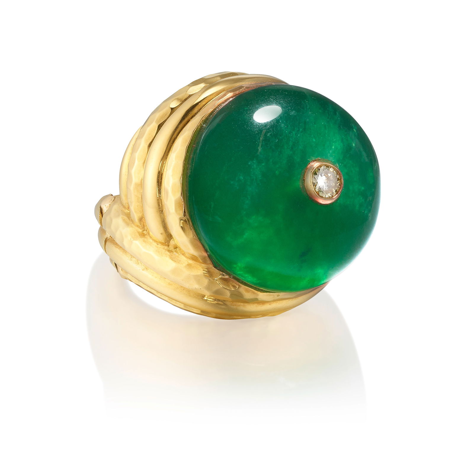 ATTRIBUTED TO ANDREW CLUNN: AN 18K GOLD, CHRYSOPRASE AND DIAMOND RING: ATTRIBUTED TO ANDREW CLUNN: AN 18K GOLD, CHRYSOPRASE AND DIAMOND RINGComprising a carved cabochon chrysoprase in a hammered gold mounting, accented with a single round brilliant-cut diamond; 
