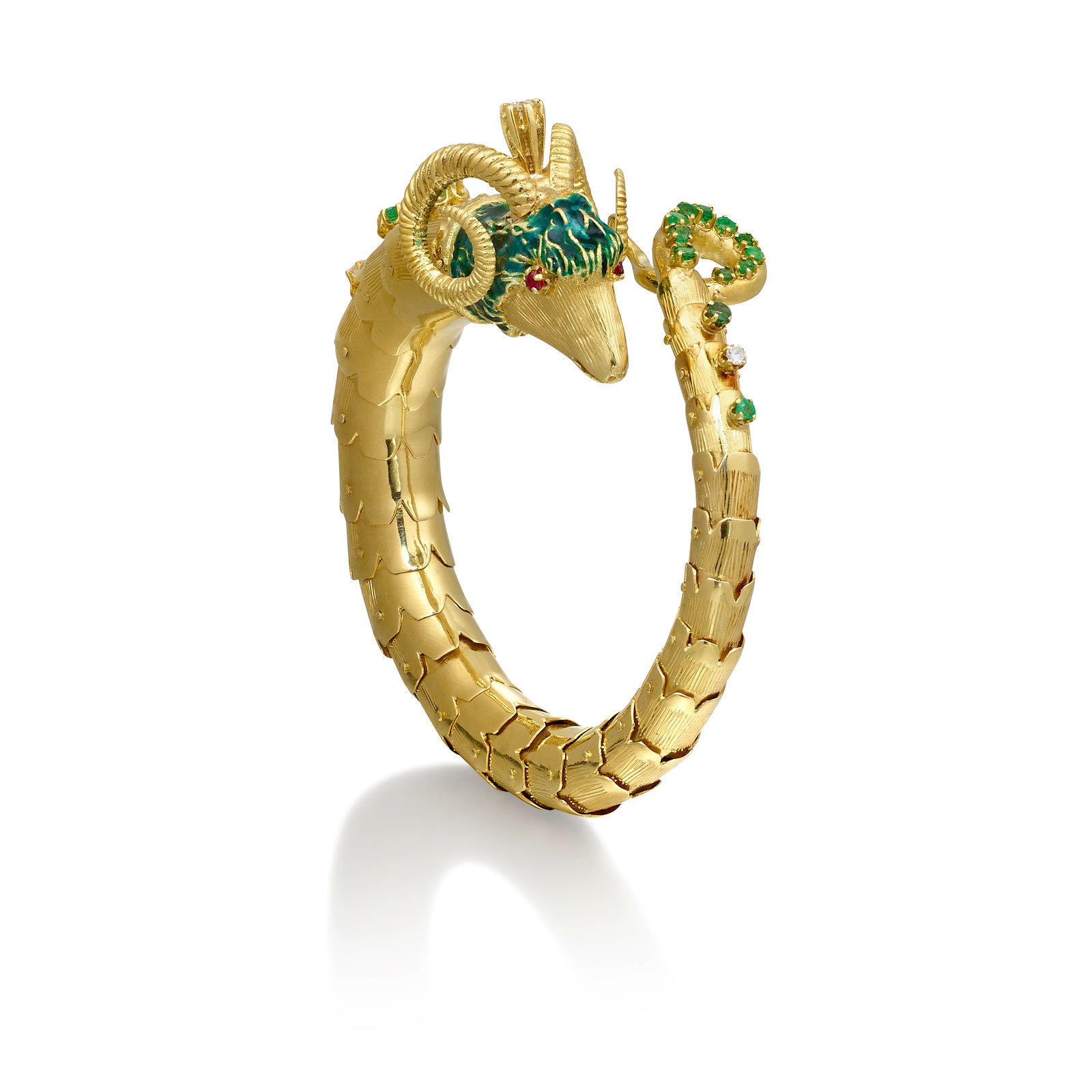 AN ENAMEL, DIAMOND AND GEM-SET BRACELET: AN ENAMEL, DIAMOND AND GEM-SET BRACELETA flexible bangle designed as a ram, with green enamel detail, accented throughout with round rubies, emeralds and round brilliant-cut diamonds; composed of 14k