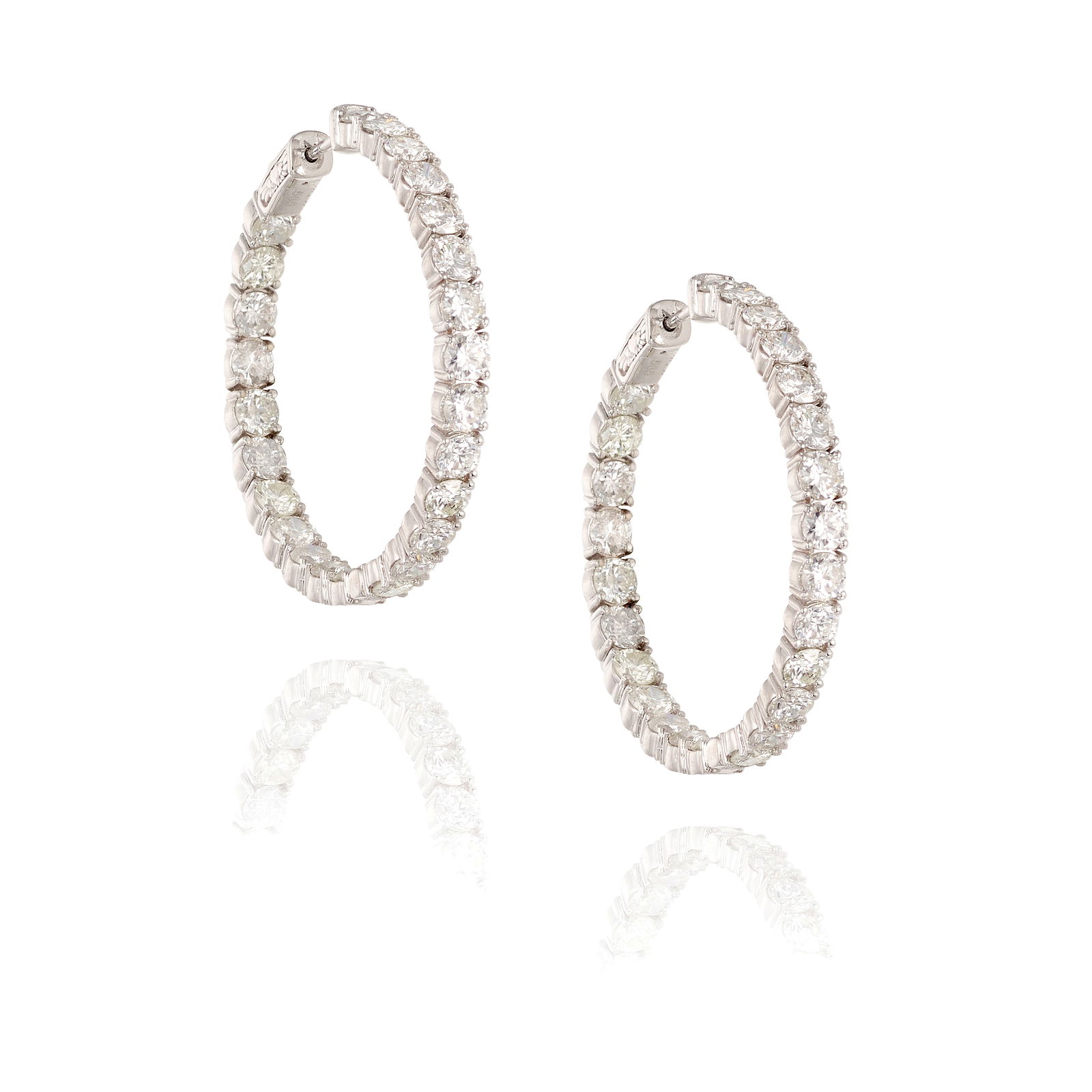 A PAIR OF 14K WHITE GOLD AND DIAMOND EARRINGS: A PAIR OF 14K WHITE GOLD AND DIAMOND EARRINGSComprising round brilliant-cut diamonds; estimated total diamond weight 9.95 carats; measures 1 5/8 in.Footnotes:OVERALL CONDITION:Metal stamped and
