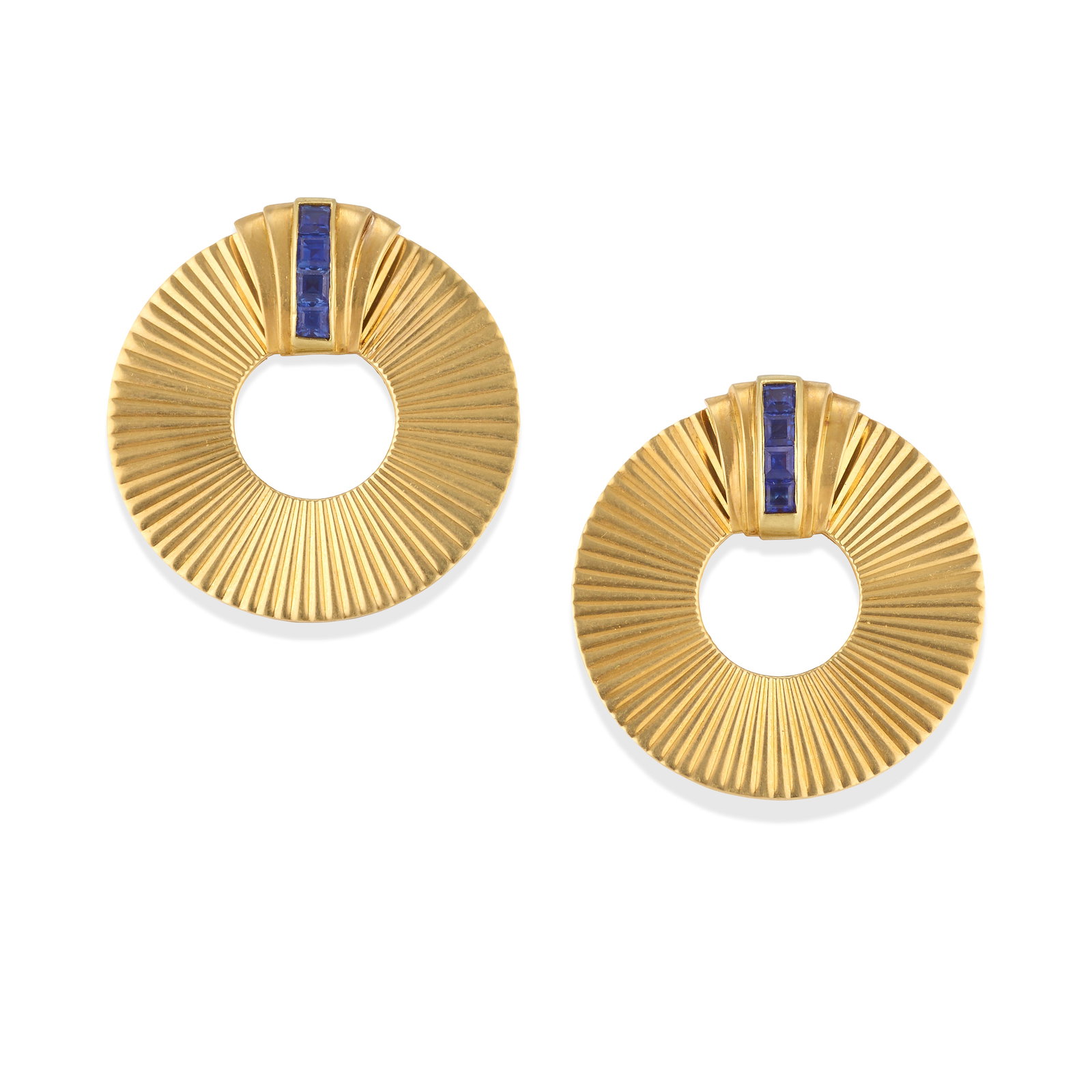 TIFFANY & CO.: A SET OF 14K GOLD AND SAPPHIRE CLIP BROOCHES, CIRCA 1950: TIFFANY & CO.: A SET OF 14K GOLD AND SAPPHIRE CLIP BROOCHES, CIRCA 1950 Each of circular, fluted gold design, accented by square step-cut sapphires, each with partial Tiffany & Co. signatures, measure