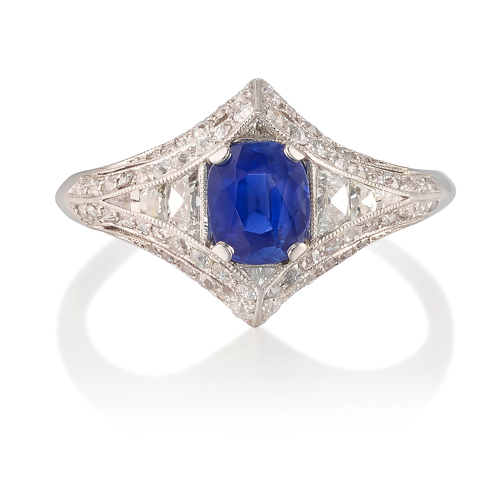 TIFFANY & CO.: A SAPPHIRE AND DIAMOND RING, CIRCA 1915: TIFFANY & CO.: A SAPPHIRE AND DIAMOND RING, CIRCA 1915 Centering a cushion-shaped sapphire, weighing 1.06 carats, flanked by calibré-cut diamonds and further accented by old European, old mine an