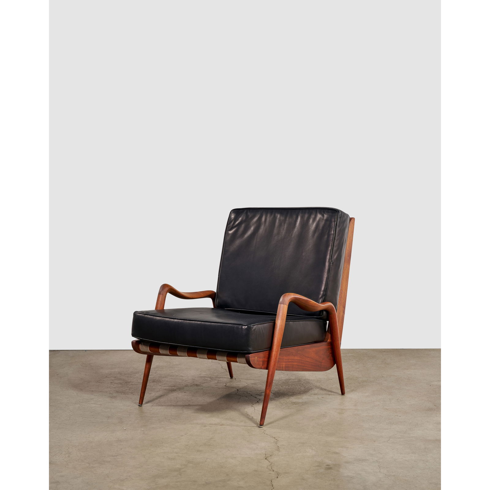 PHILLIP LLOYD POWELL (1919-2008) Rare 'New Hope' Chaircirca 1960sculpted walnut, webbing, black ... (1 of 1)