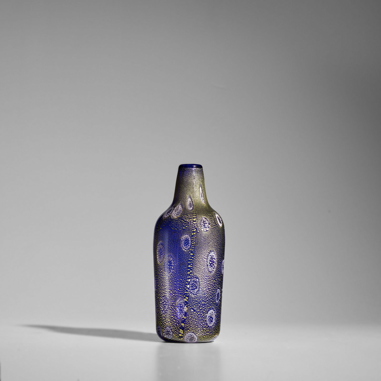 ALDO NASON (BORN 1920) Vasecirca 1960for A.V.E.M., hand-blown glass internally decorated with go...: ALDO NASON (BORN 1920) Vase circa 1960 for A.V.E.M., hand-blown glass internally decorated with gold foil and murrines height 10in (25.5cm); diameter 4 1/2in (11.5cm) This lot is subject to the follow