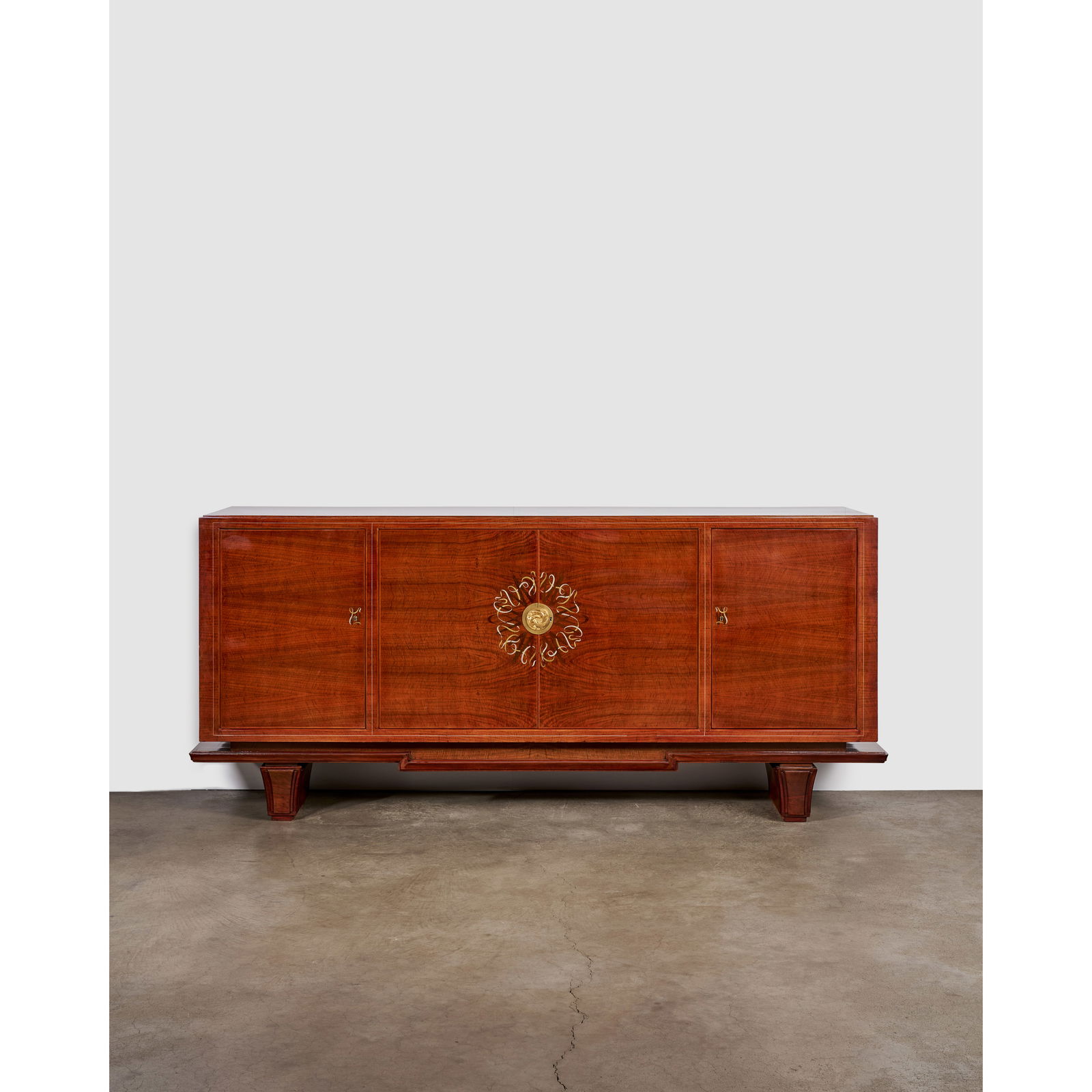 MAISON DOMINIQUE (1922-1970) Four-Door Credenzacirca 1960inlaid mahogany, brass, gilt-bronze esc...: MAISON DOMINIQUE (1922-1970) Four-Door Credenza circa 1960 inlaid mahogany, brass, gilt-bronze escutcheon height 33 1/2in (85cm); length 90in (228.6cm); depth 22in (56cm) Footnotes: Provenance L'Art d