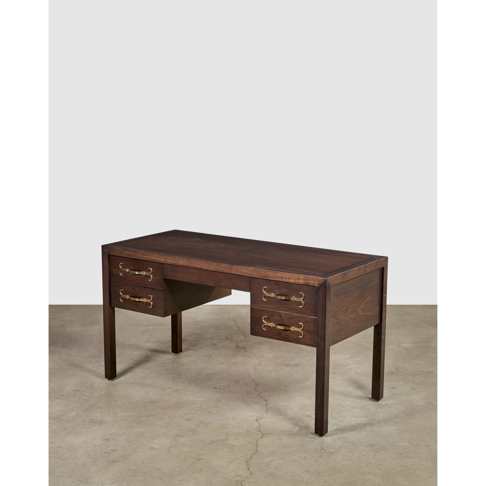 TOMMI PARZINGER (1930-1991) Deskcirca 1960walnut, brass inlay, drawer with branded mark 'Parzing...: TOMMI PARZINGER (1930-1991) Desk circa 1960 walnut, brass inlay, drawer with branded mark 'Parzinger Originals' height 30in (76cm); width 54in (137cm); depth 24in (61cm) This lot is subject to the fol