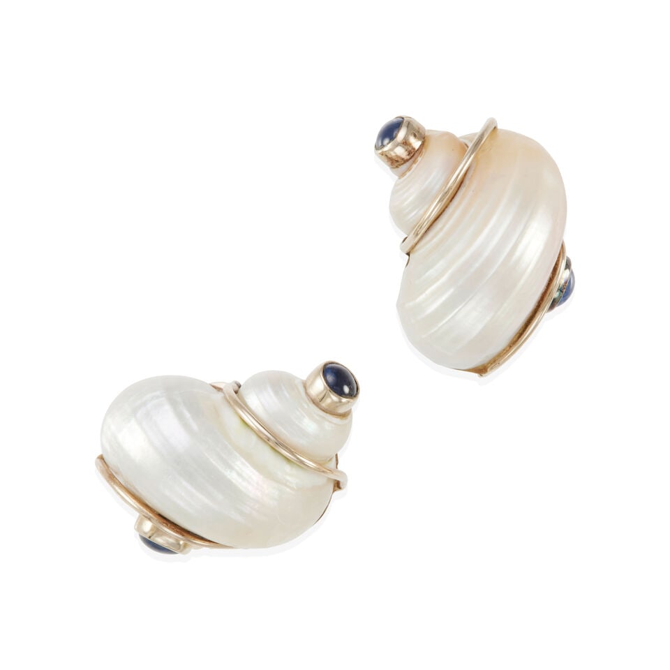 SEAMAN SCHEPPS: 14K GOLD, SHELL, AND SAPPHIRE EAR CLIPS: SEAMAN SCHEPPS: 14K GOLD, SHELL, AND SAPPHIRE EAR CLIPS • 14k yellow gold • 2 shells measuring 25.00 x 22.00 x 21.00 mm • 4 round or oval shape cabochon sapphires weighing