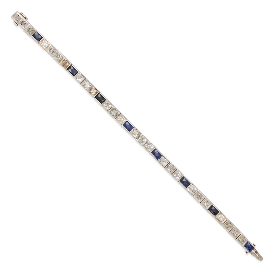 ART DECO ERA PLATINUM, DIAMOND, AND SYNTHETIC SAPPHIRE STRAIGHT-LINE BRACELET: ART DECO ERA PLATINUM, DIAMOND, AND SYNTHETIC SAPPHIRE STRAIGHT-LINE BRACELET • Platinum • Numerous Old European, Old Mine, and round single diamonds weighing approximately 3.25 - 3.35