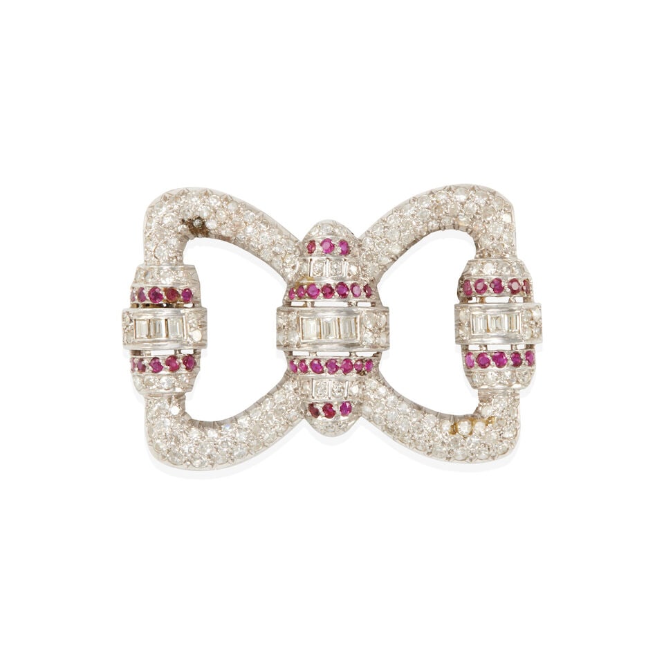 ART DECO ERA PLATINUM, DIAMOND, AND RUBY BROOCH: ART DECO ERA PLATINUM, DIAMOND, AND RUBY BROOCH • Platinum • Numerous round, single, and baguette diamonds weighing approximately 2.40 - 2.45 carats total • Numerous round rubies