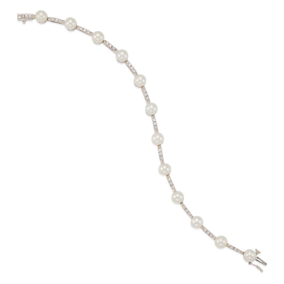 14K WHITE GOLD, DIAMOND, AND CULTURED PEARL BRACELET: 14K WHITE GOLD, DIAMOND, AND CULTURED PEARL BRACELET • 14k white gold • 12 spherical half-drilled saltwater cultured pearls measuring 6.00 mm each • Numerous round diamonds weighing