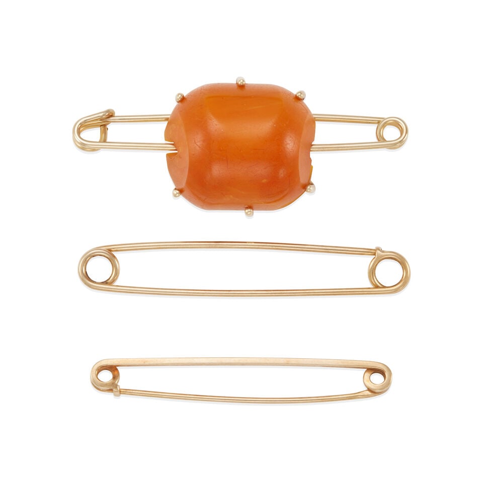 GOLD AND AMBER PIN SET: GOLD AND AMBER PIN SET • Two pins of 14k yellow gold, length 2 1/16 in. and 2 3/8 in., signed Tiffany & Co., estimated weight 7.1 grams • 1 12k gold-filled pin with amber element,
