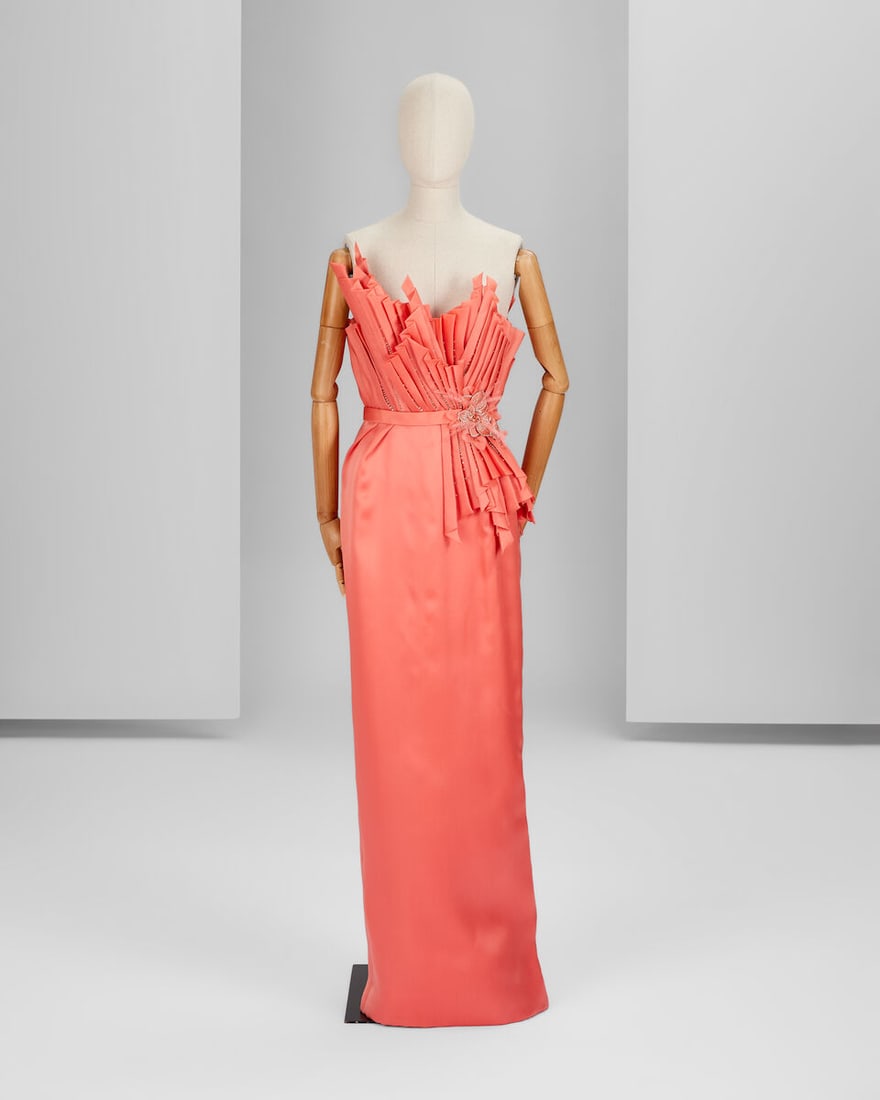Ralph & Russo Haute Couture Exclusive: Coral Silk Pleated Gown: Ralph & Russo Haute Couture Exclusive: Coral Silk Pleated Gown Coral silk gazar long corset gown featuring a fan pleating motif encrusted with Swarovski crystals and a jewelled flower Approximate
