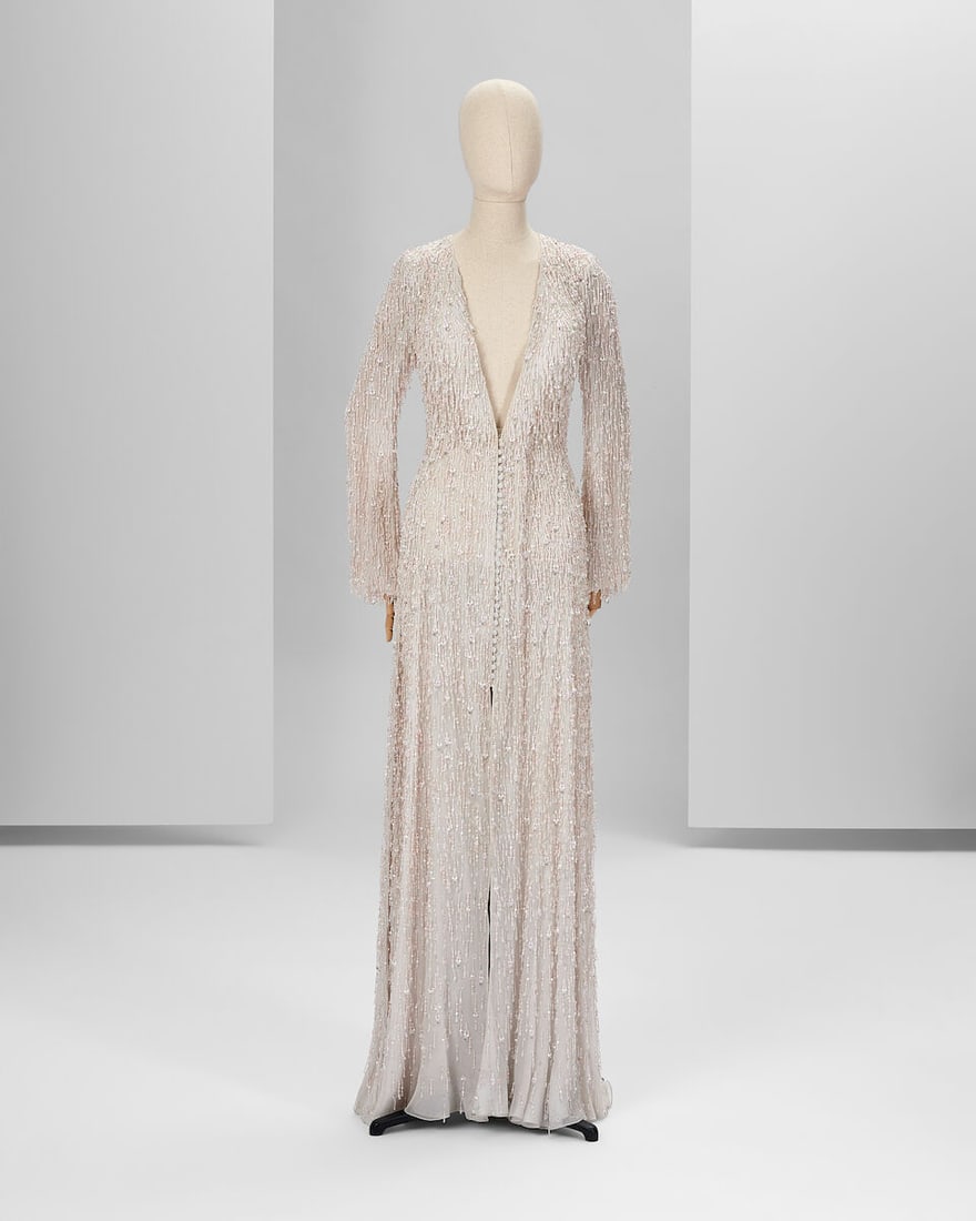 Ralph & Russo Haute Couture Exclusive: White Embroidered Tulle Gown: Ralph & Russo Haute Couture Exclusive: White Embroidered Tulle Gown White embroidered tulle gown featuring long flare sleeves, V-neckline and central front fastening up to knee level, embellished