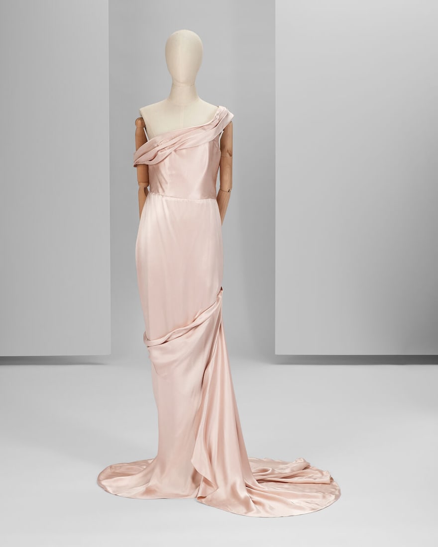 Ralph & Russo Haute Couture Exclusive: Champagne Pink Satin Gown: Ralph & Russo Haute Couture Exclusive: Champagne Pink Satin Gown Champagne pink double silk satin asymmetric fishtail gown featuring oblique pleating details and a side drape trail Approximate