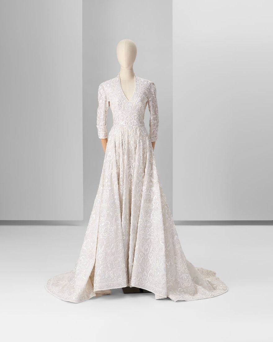 Ralph & Russo Haute Couture Exclusive: Off White Silk Marocain Bridal Gown: Ralph & Russo Haute Couture Exclusive: Off White Silk Marocain Bridal Gown Off-white silk marocain bridal gown with V-neck and three-quarter fitted sleeves with high turn-ups, a fitted bodice and
