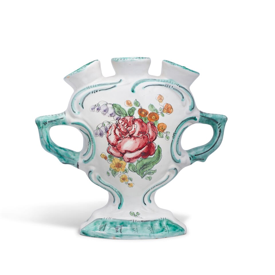 A French faience tulipière, early 20th century: A French faience tulipière, early 20th century Decorated with floral sprays under green borders and spurious 'Jacques Boselly' mark and '941' in black script, 19cm high For further information