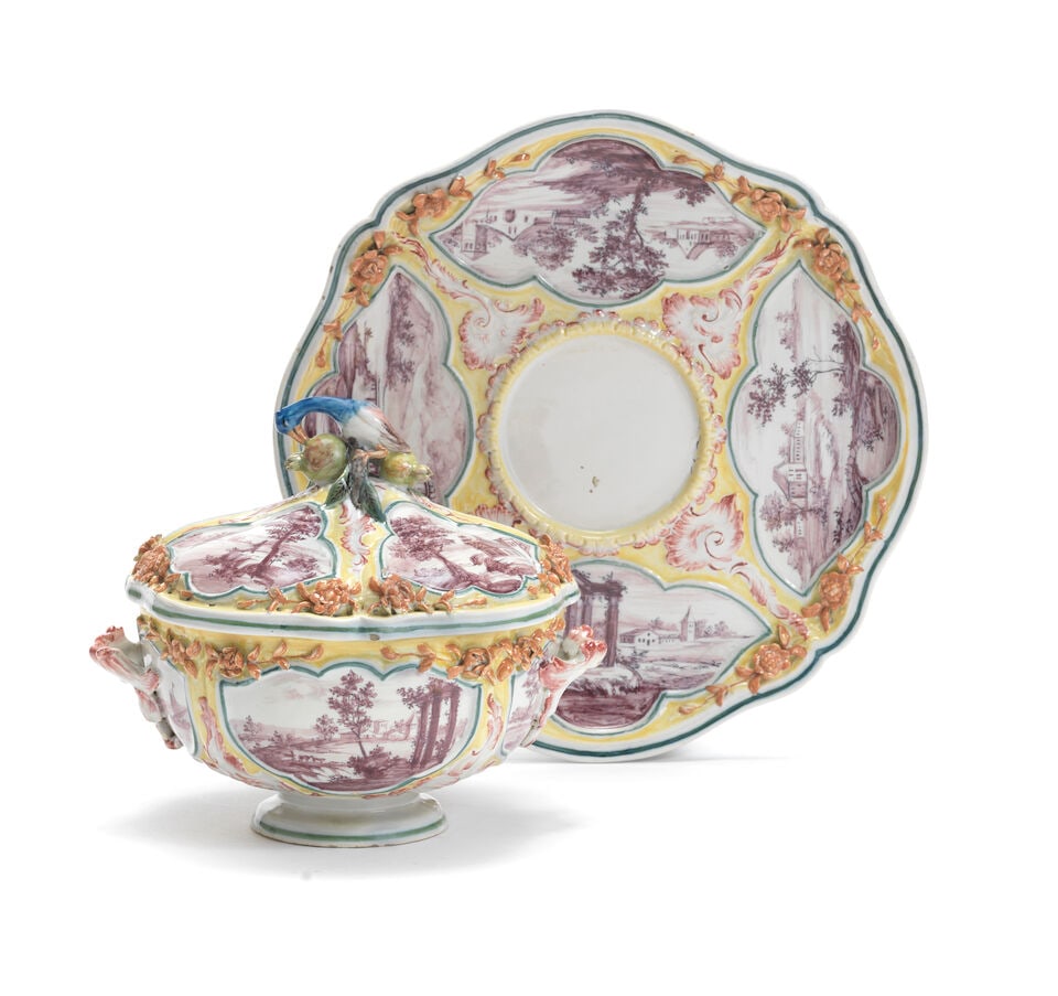 A 20th century Nove, Antonibon style faience ecuelle, cover and stand: A 20th century Nove, Antonibon style faience ecuelle, cover and stand Moulded with green-edged, recessed and lobed panels painted in puce camaieu with ruins and buildings in landscapes, the yellow