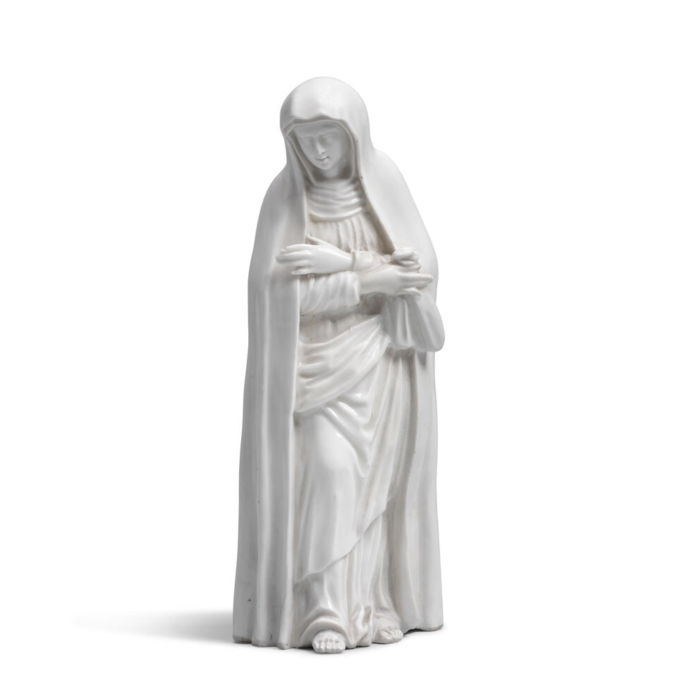 A European porcelain figure of a female Saint, perhaps representing Mater Dolorosa, the porcelai...: A European porcelain figure of a female Saint, perhaps representing Mater Dolorosa, the porcelain possibly early Vienna, 18th century Her arms crossed over her chest, the porcelain left in the white,
