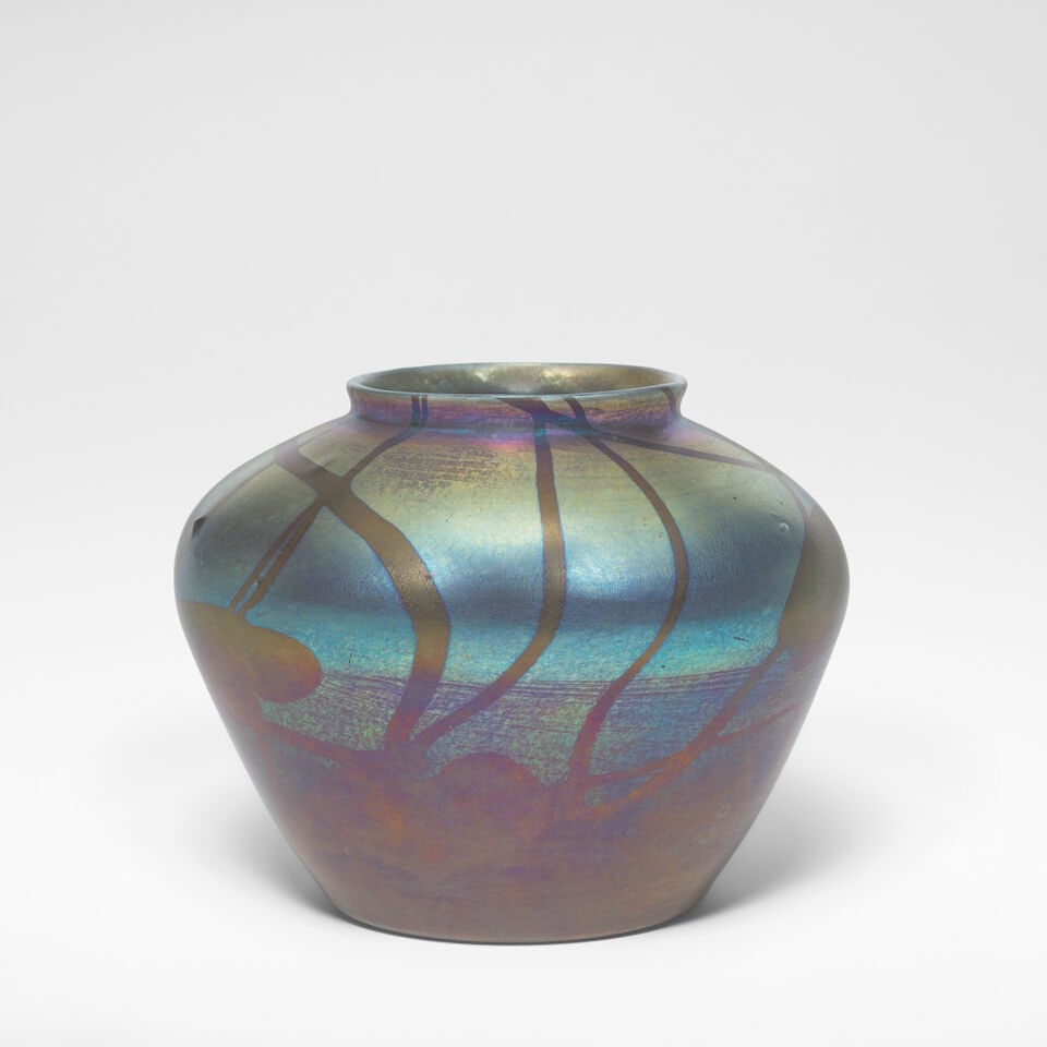 Tiffany Studios 'Leaf and Vine' vase, circa 1905: Tiffany Studios 'Leaf and Vine' vase, circa 1905 Iridescent and red glass. 12.5 cm high, 16 cm diameter With manufacturer's label to the pontil, the base incised 5338C L.C. Tiffany