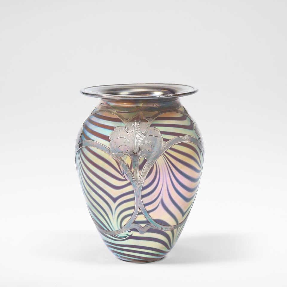 Durand 'King Tut' vase, circa 1925: Durand 'King Tut' vase, circa 1925 Iridescent overlaid glass, the bulbous form rising to a flattened rim, the body overlaid with sterling silver in stylised floral motifs. 16 cm high, 12 cm