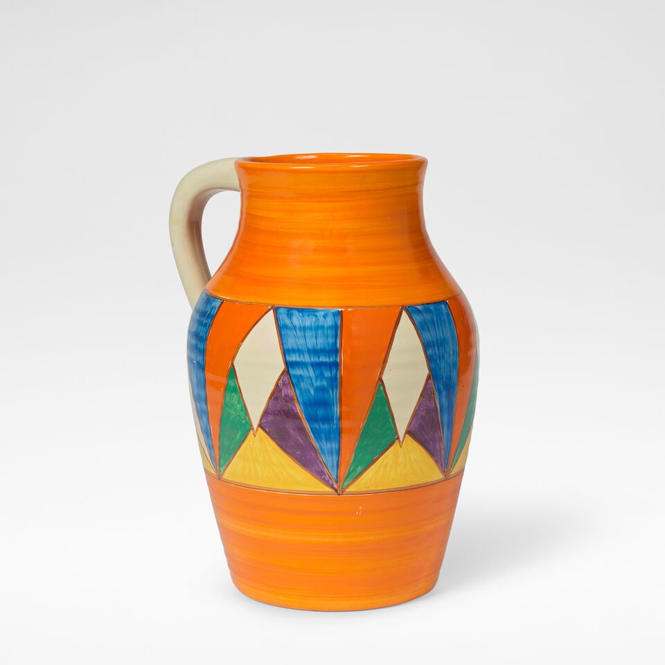 Clarice cliff 'Original Bizarre', Lotus jug, circa 1929: Clarice cliff 'Original Bizarre', Lotus jug, circa 1929 Glazed earthenware, hand painted with a stylised geometric decoration against an orange ground. 29.5 cm high, 20 cm wide, 24 cm deep Underneath