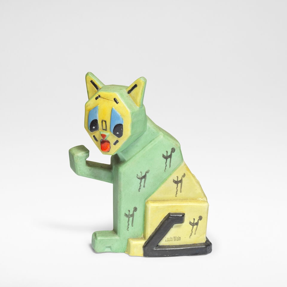 Louis Wain Lucky Futurist Cat, designed circa 1915, executed circa 1930: Louis Wain Lucky Futurist Cat, designed circa 1915, executed circa 1930 Bisque porcelain, decorated in polychrome. 12.5 cm high, 9.5 cm wide, 5 cm deep Stamped to the side LOUIS WAIN and to the base