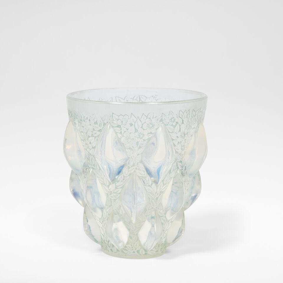 René Lalique 'Rampillon' vase, designed 1927: René Lalique 'Rampillon' vase, designed 1927 Opalescent glass, with floral decoration in low relief with blue staining. 13 cm high, 11.5 cm diameter Wheelcut to the base R LALIQUE FRANCE and