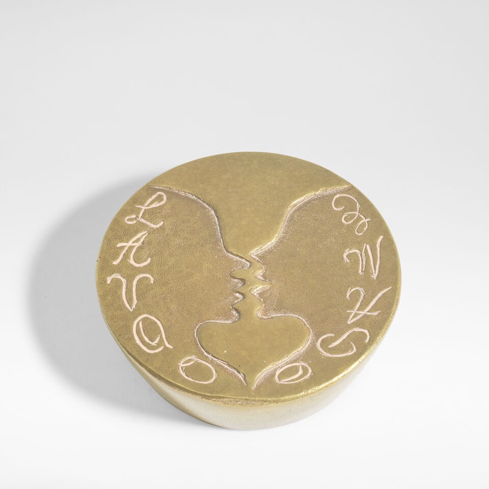 Line Vautrin 'Elle a vécu occupée à aimer' presse-papier, circa 1950: Line Vautrin 'Elle a vécu occupée à aimer' presse-papier, circa 1950 Gilt-bronze, intaglio modelled as two figures forming a heart shape, with the letters 'L A V Q O Q P A M E' inscribe