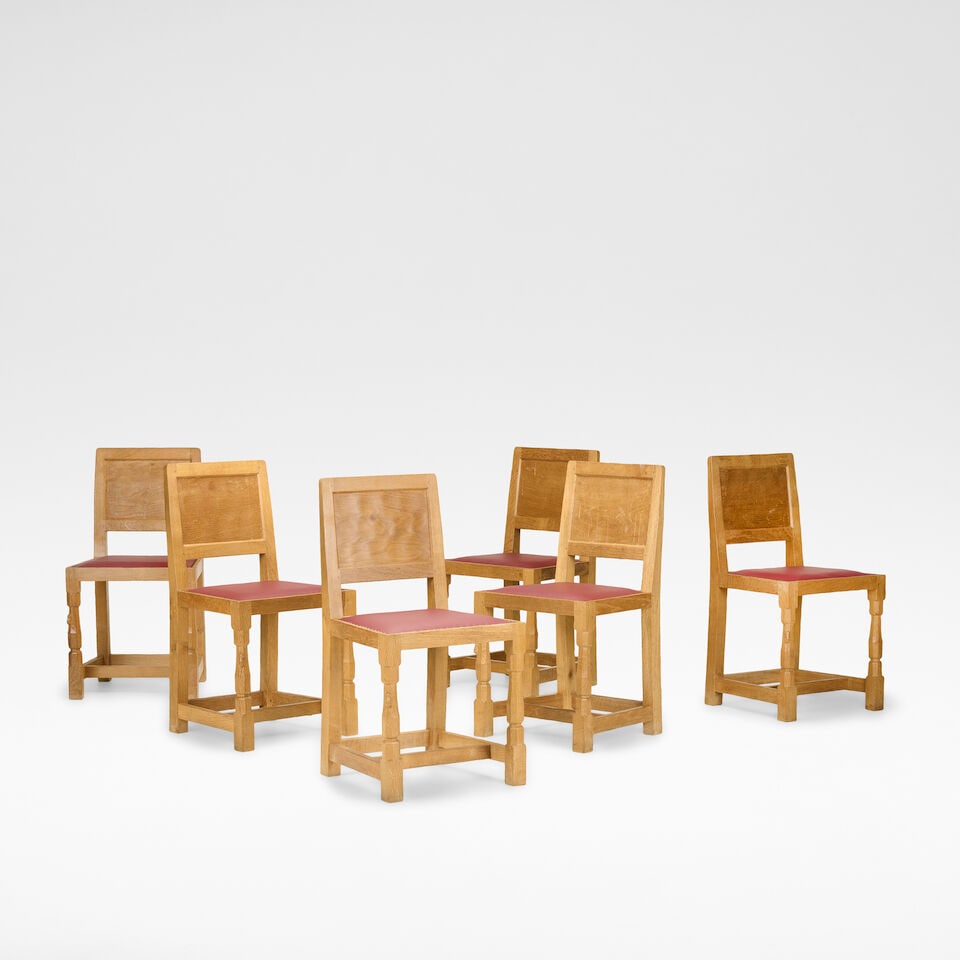 Robert 'Mouseman' Thompson Set of six dining chairs, circa 1950: Robert 'Mouseman' Thompson Set of six dining chairs, circa 1950 Oak, with panelled backs, upholstered in burgundy leather, raised to the front on carved supports. Each: 85 cm high, 45 cm wide, 43 cm